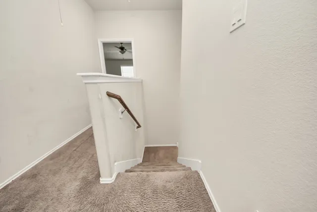 a view of a hallway with staircase