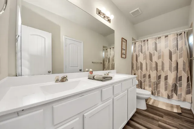 a bathroom with double sink and a mirror