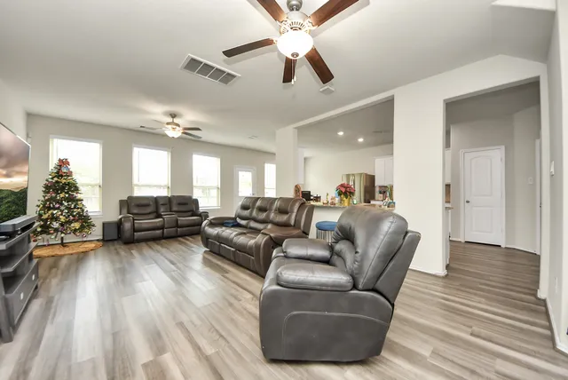 a living room with furniture and a chandelier