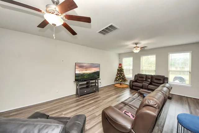 a living room with furniture and a flat screen tv