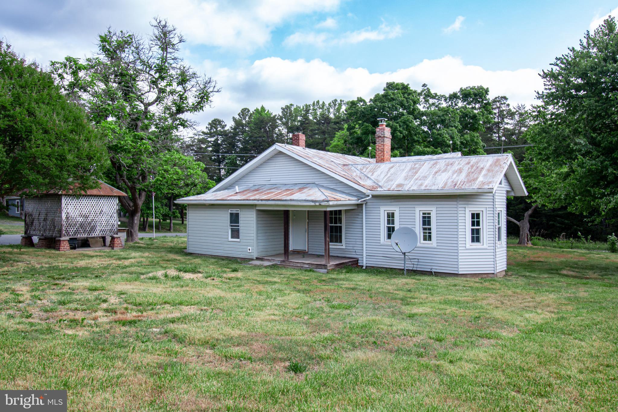 198 Mt Hope Church Road Bumpass, VA 23024 - Photo 3 of 25 a front view of a house with a garden