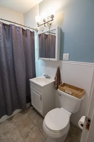 a white toilet sitting next to a bathroom sink