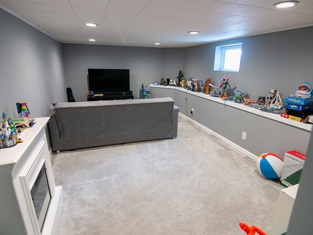 10 Makepeace Street Saugus, MA 01906 - Photo 27 of 36 a living room with furniture and a flat screen tv