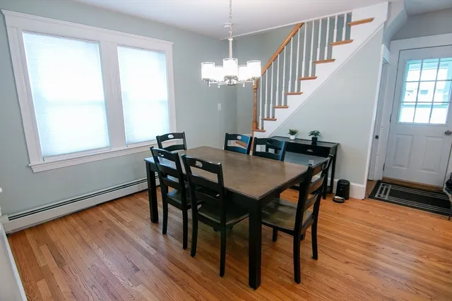 a view of a dining room with furniture window and wooden floor