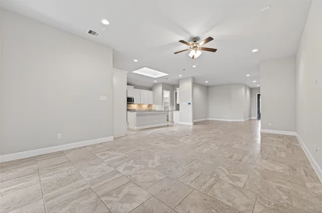 a kitchen with granite countertop a stove top oven and cabinets
