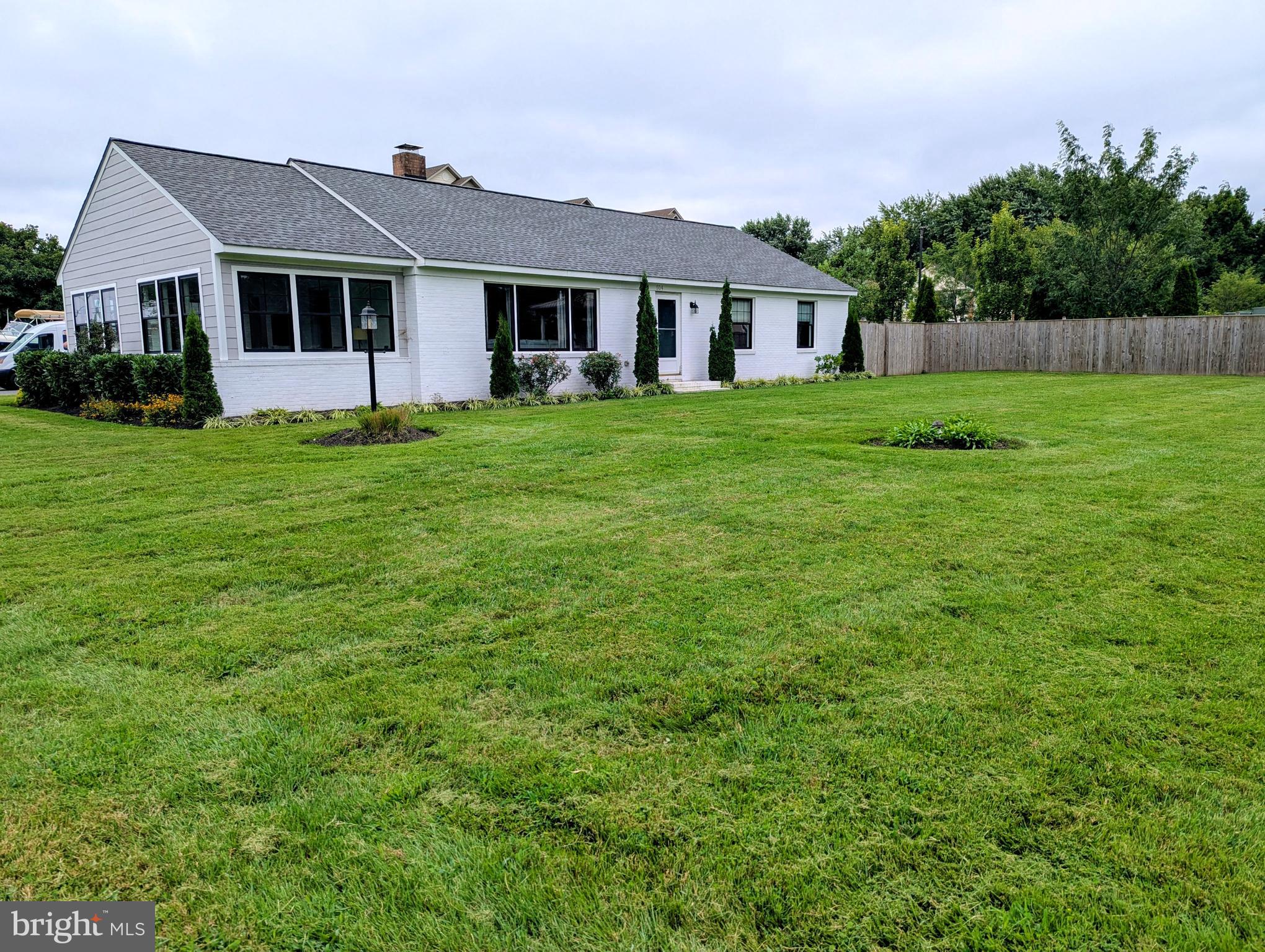 504 Main Street Stevensville, MD 21666 - Photo 1 of 30 a front view of house with yard and green space