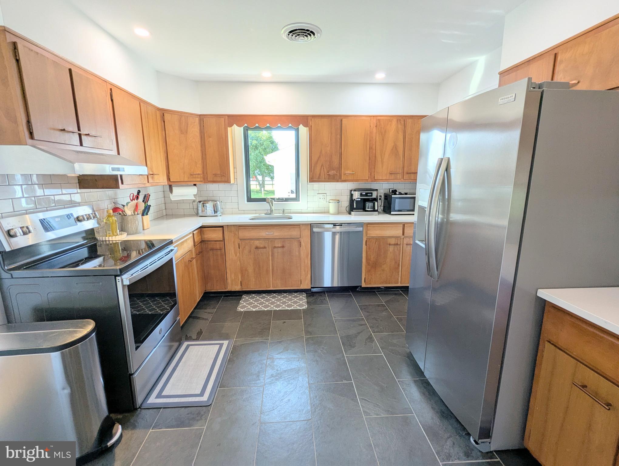 504 Main Street Stevensville, MD 21666 - Photo 11 of 30 a kitchen with a sink refrigerator and microwave