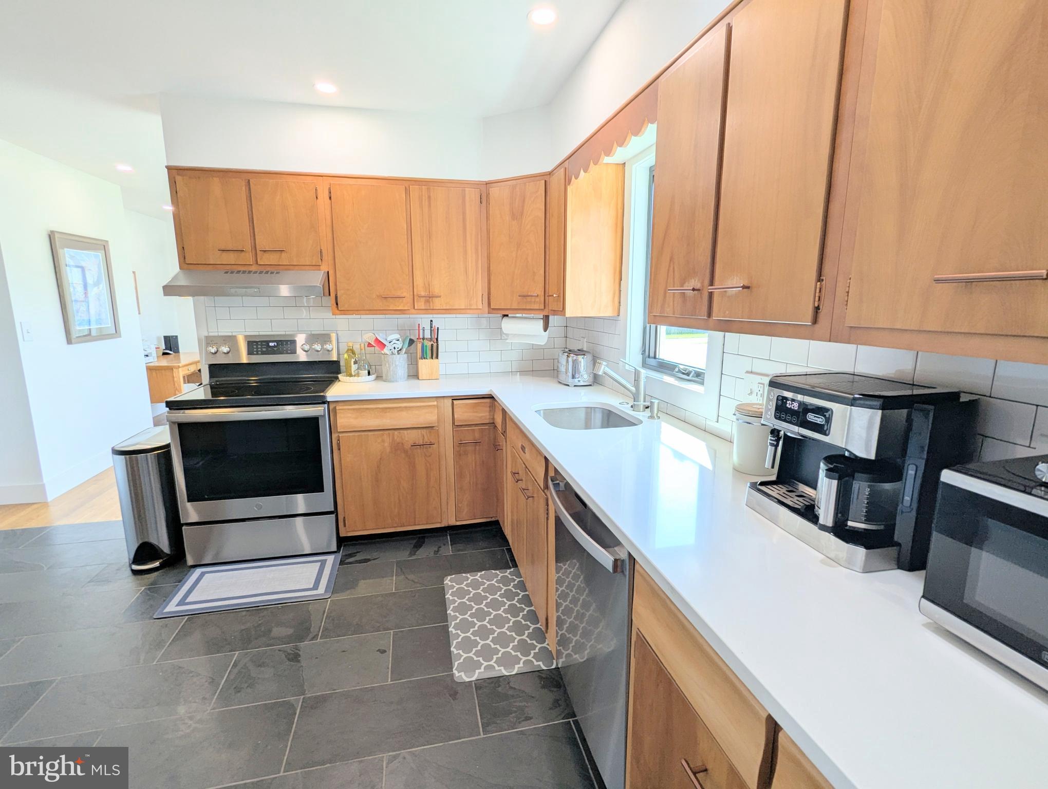 504 Main Street Stevensville, MD 21666 - Photo 12 of 30 a kitchen with a sink stove and cabinets