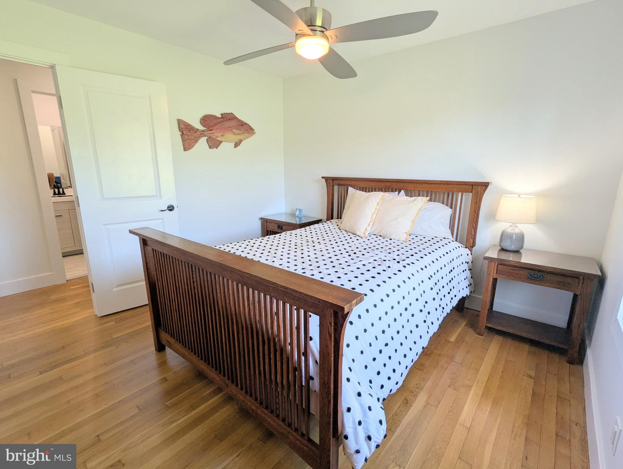 504 Main Street Stevensville, MD 21666 - Photo 19 of 30 a bedroom with a bed and wooden floor