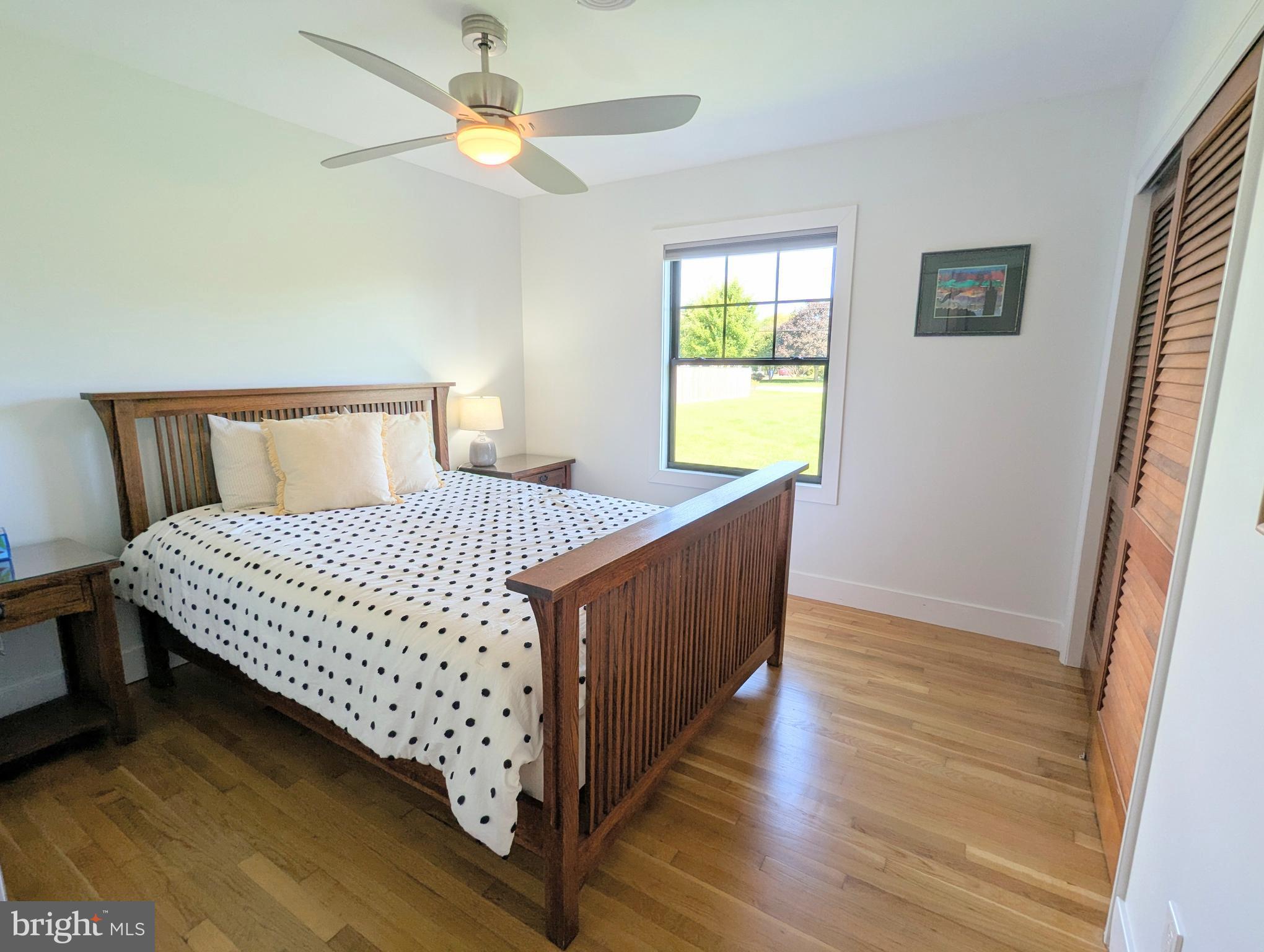 504 Main Street Stevensville, MD 21666 - Photo 20 of 30 a bedroom with a bed and a chandelier