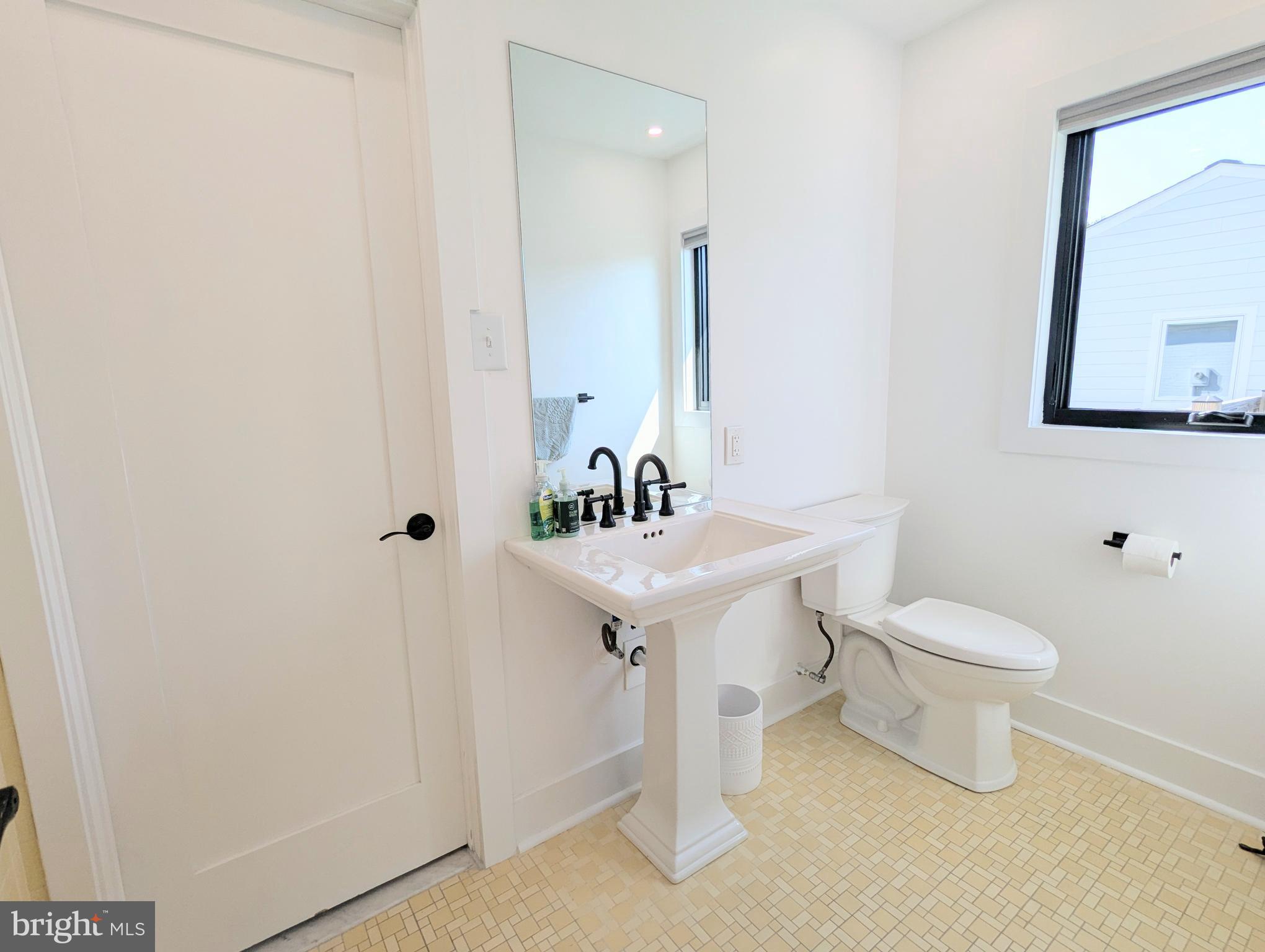 504 Main Street Stevensville, MD 21666 - Photo 24 of 30 a bathroom with a sink toilet and a mirror