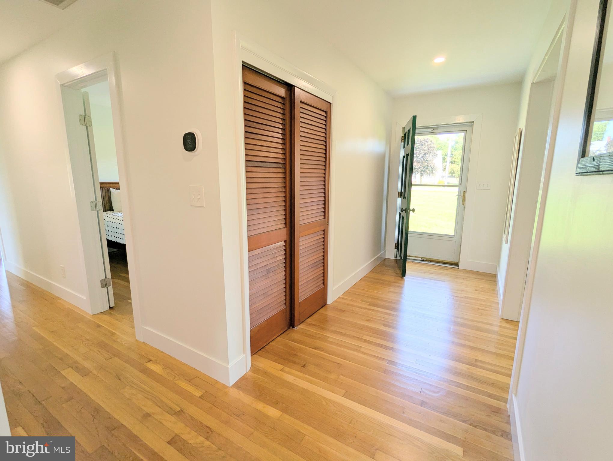 504 Main Street Stevensville, MD 21666 - Photo 27 of 30 a view of a hallway with wooden floor and closet