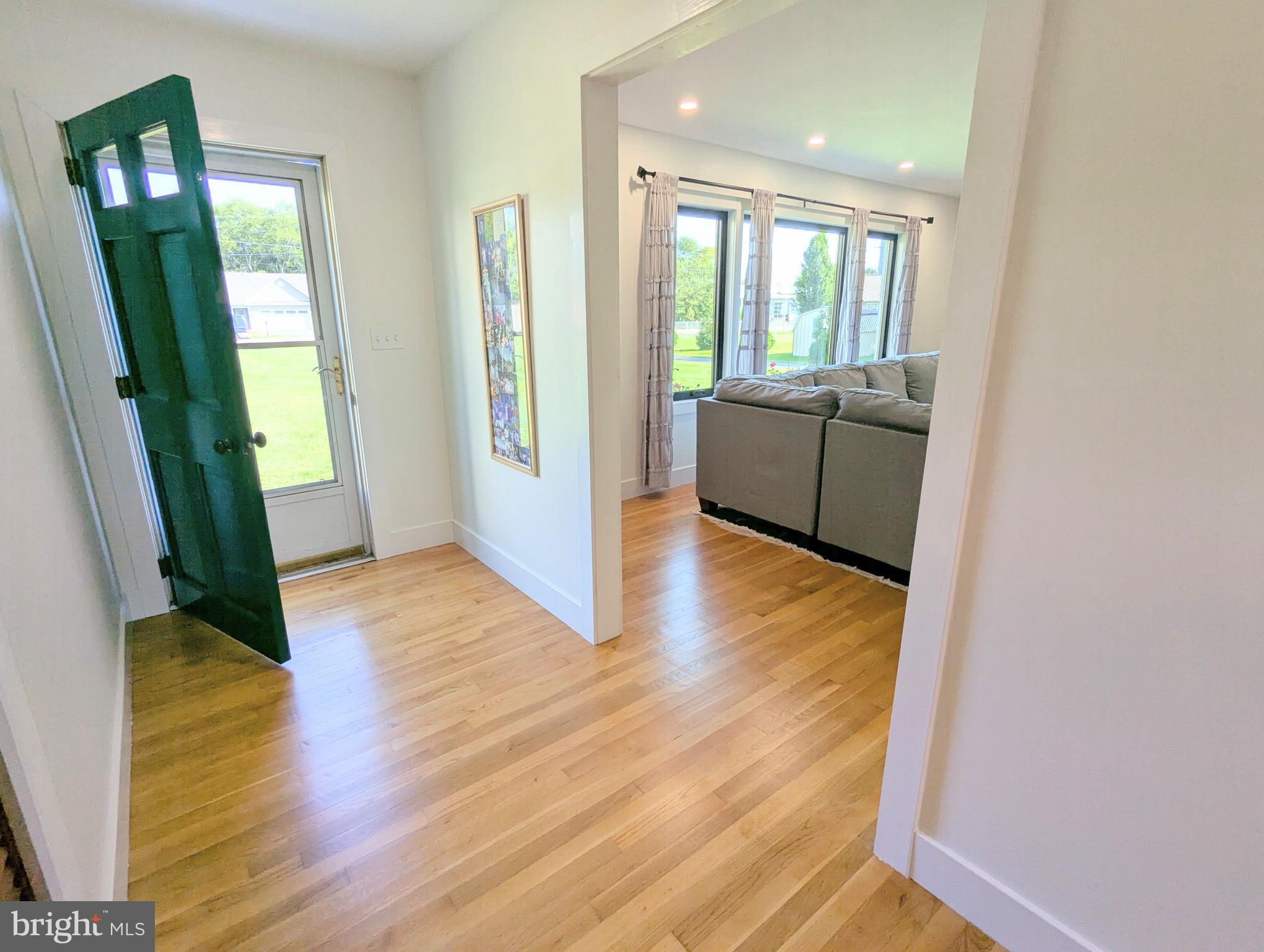504 Main Street Stevensville, MD 21666 - Photo 28 of 30 a view of a hallway with wooden floor and a bathroom
