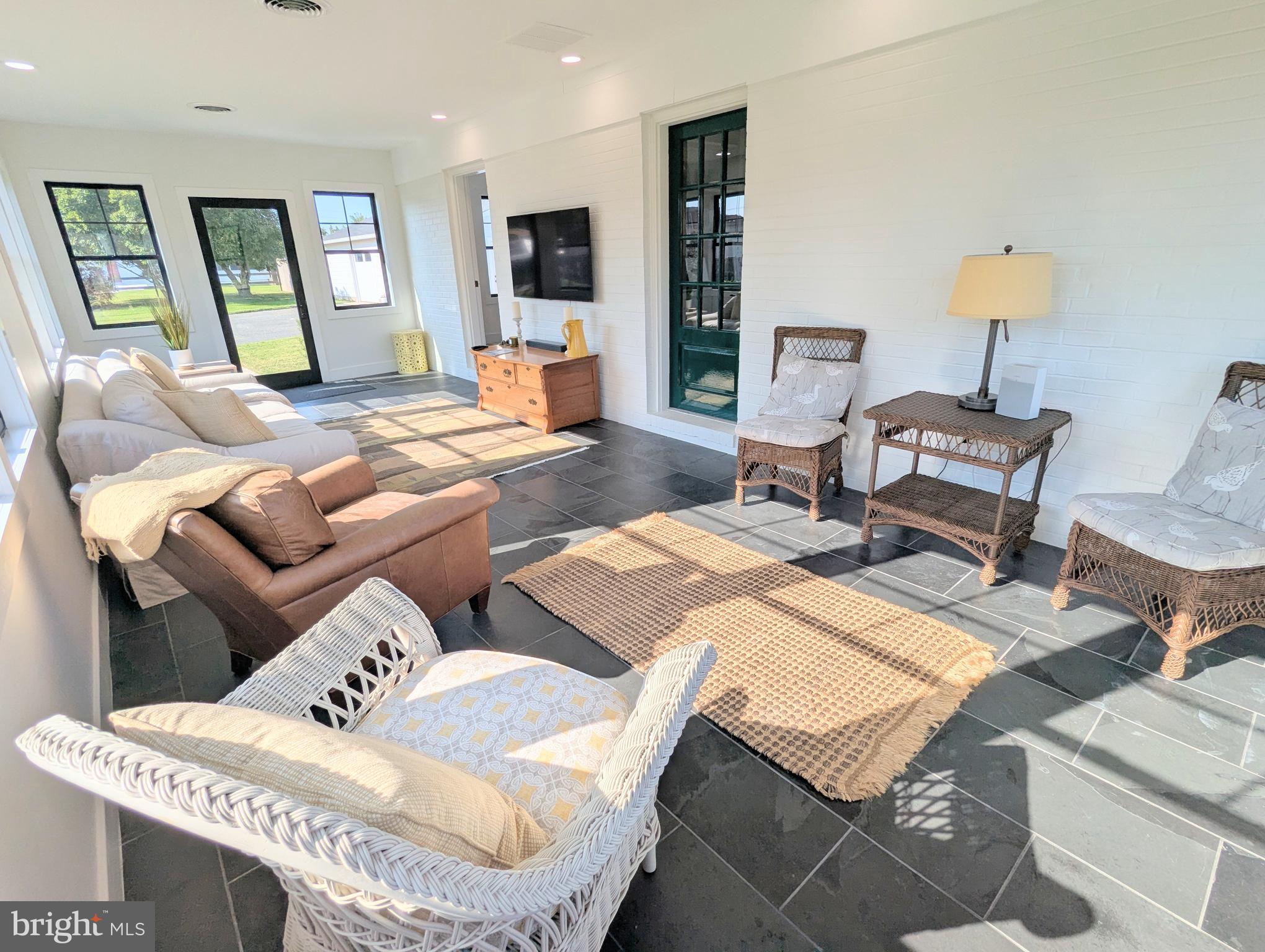 504 Main Street Stevensville, MD 21666 - Photo 3 of 30 a living room with furniture and a table