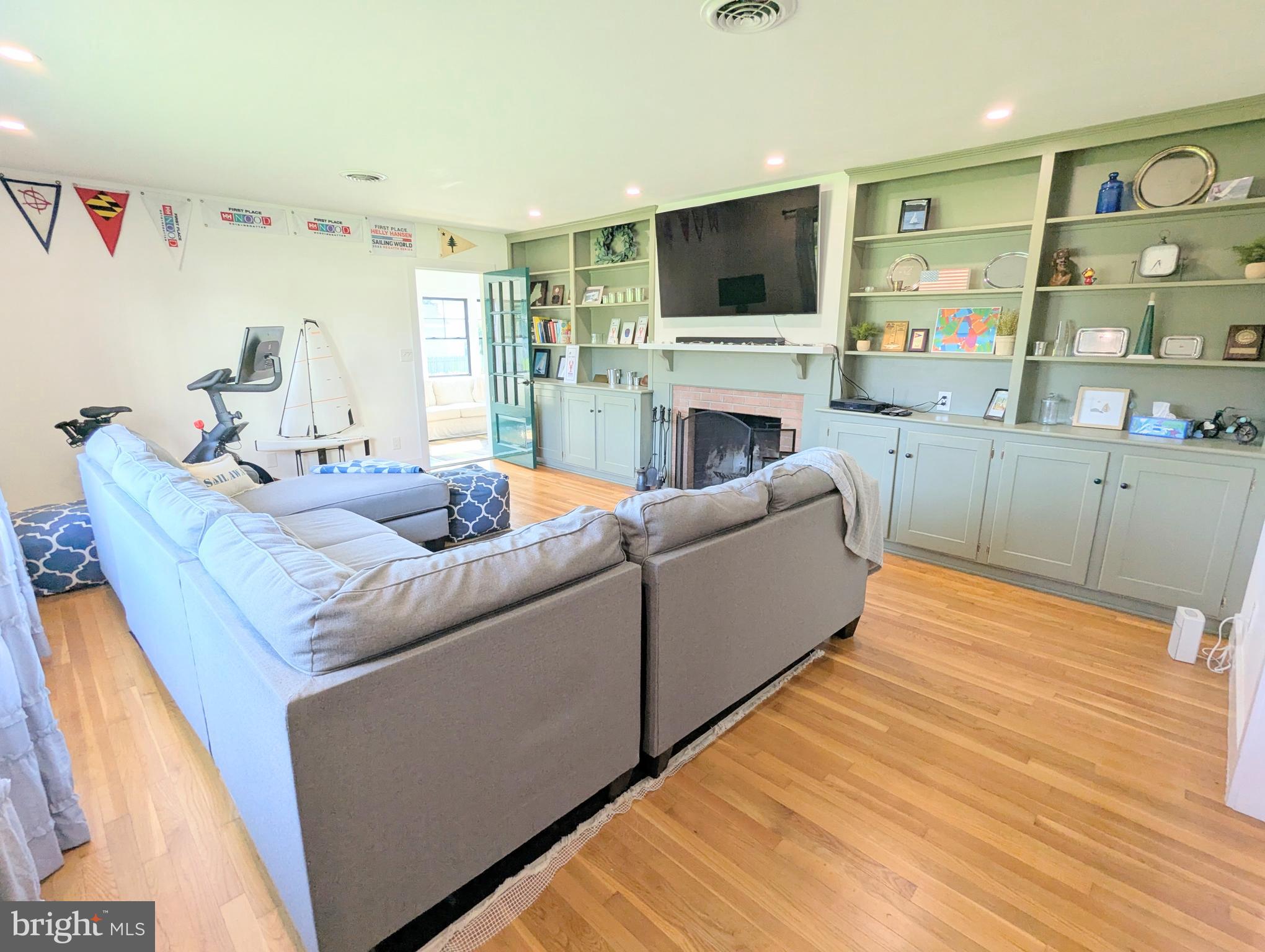 504 Main Street Stevensville, MD 21666 - Photo 8 of 30 a living room with furniture a flat screen tv and a fireplace