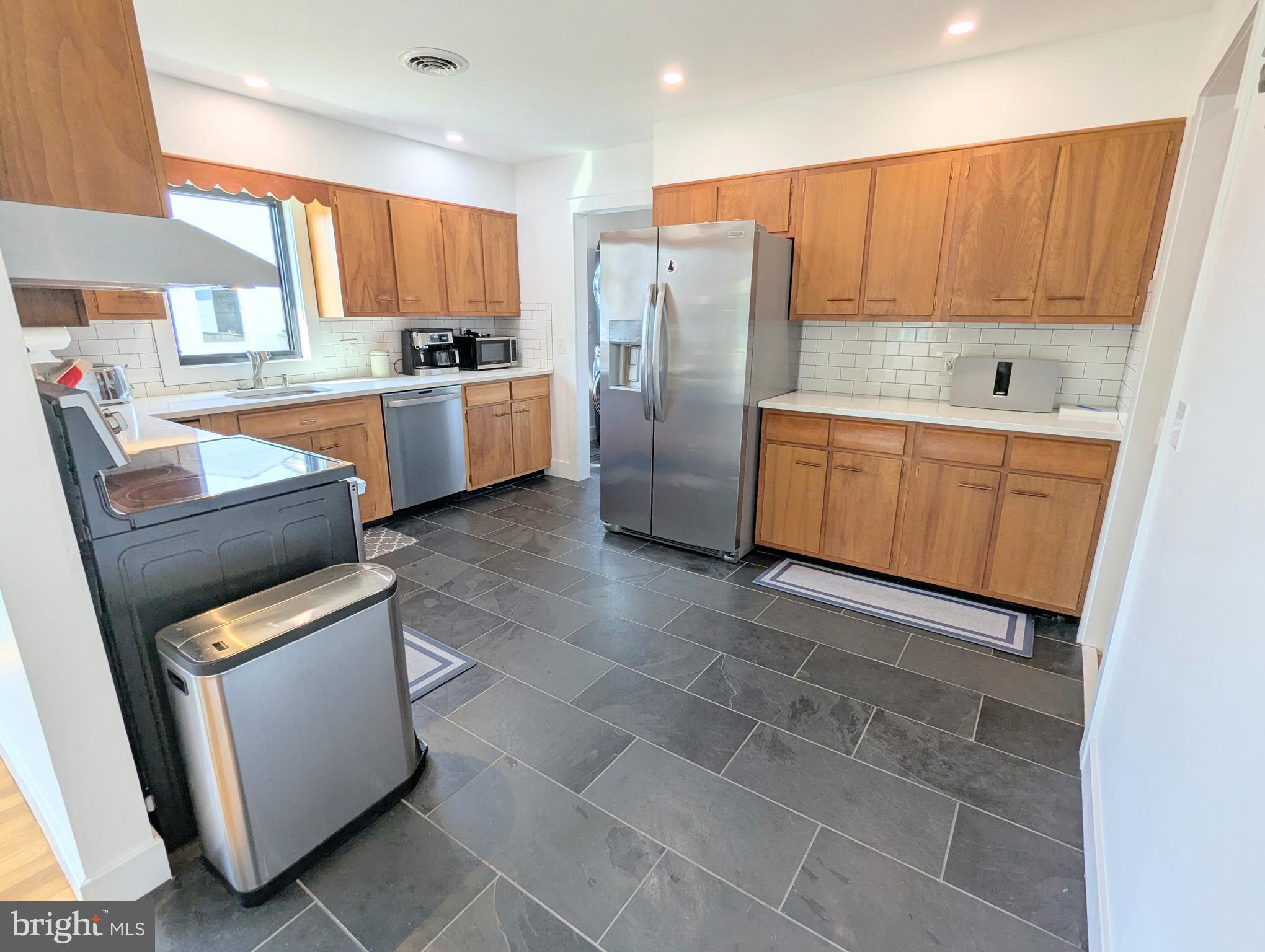 504 Main Street Stevensville, MD 21666 - Photo 10 of 30 a kitchen with a refrigerator a stove top oven and a sink