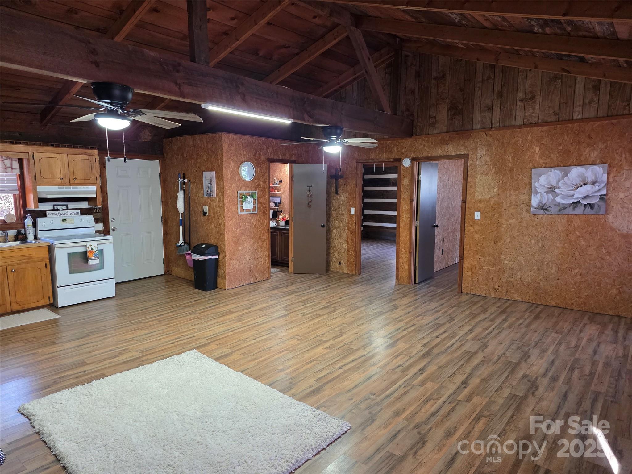 536 Hickory Springs Road Burnsville, NC 28714 - Photo 11 of 26 an empty room with wooden floor and windows