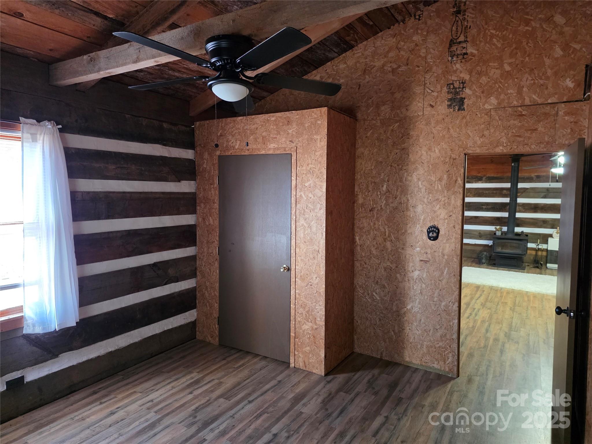536 Hickory Springs Road Burnsville, NC 28714 - Photo 16 of 26 a view of an empty room with wooden floor and a window