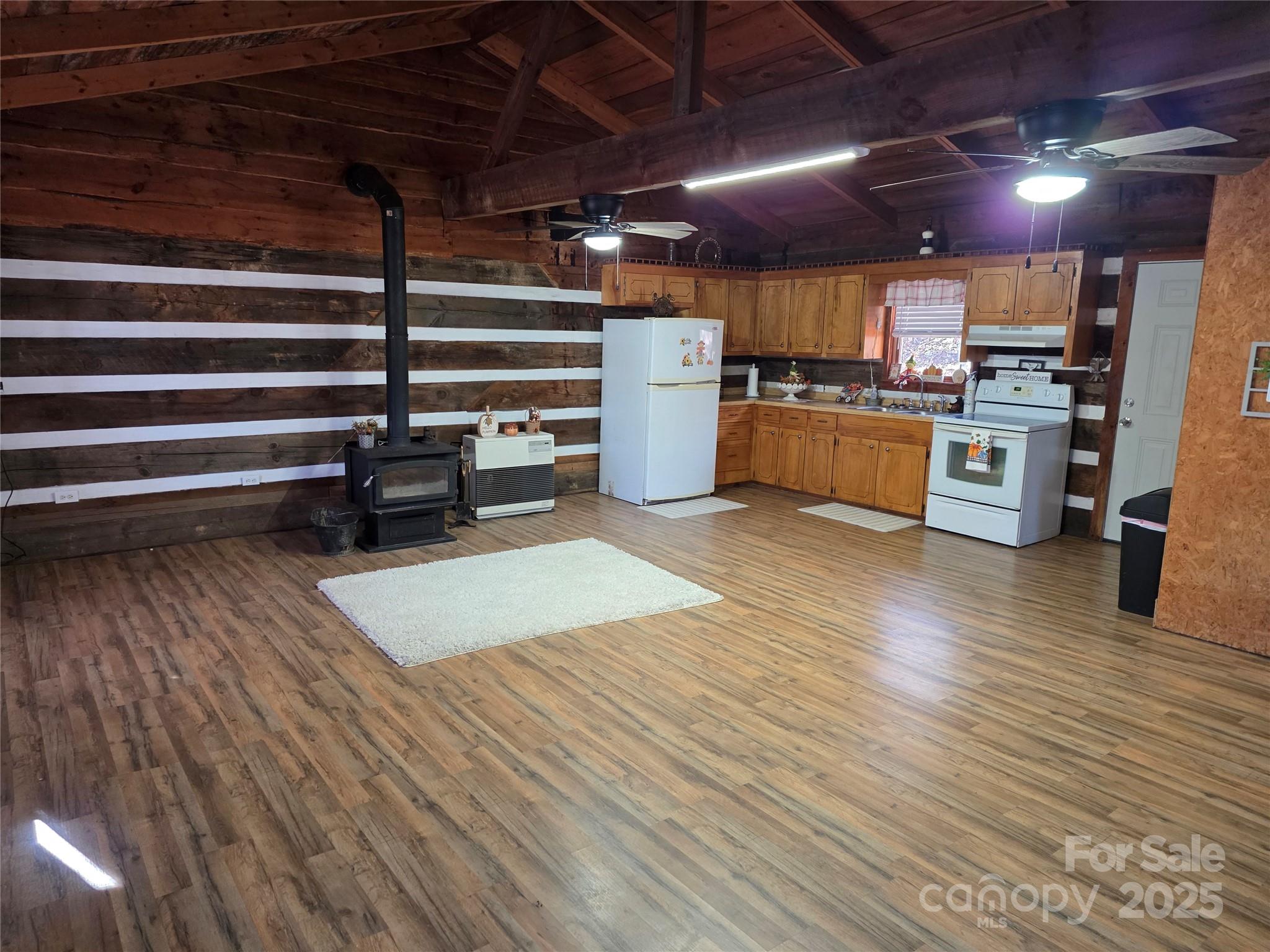 536 Hickory Springs Road Burnsville, NC 28714 - Photo 7 of 26 a kitchen with stainless steel appliances wooden floor a stove and a refrigerator