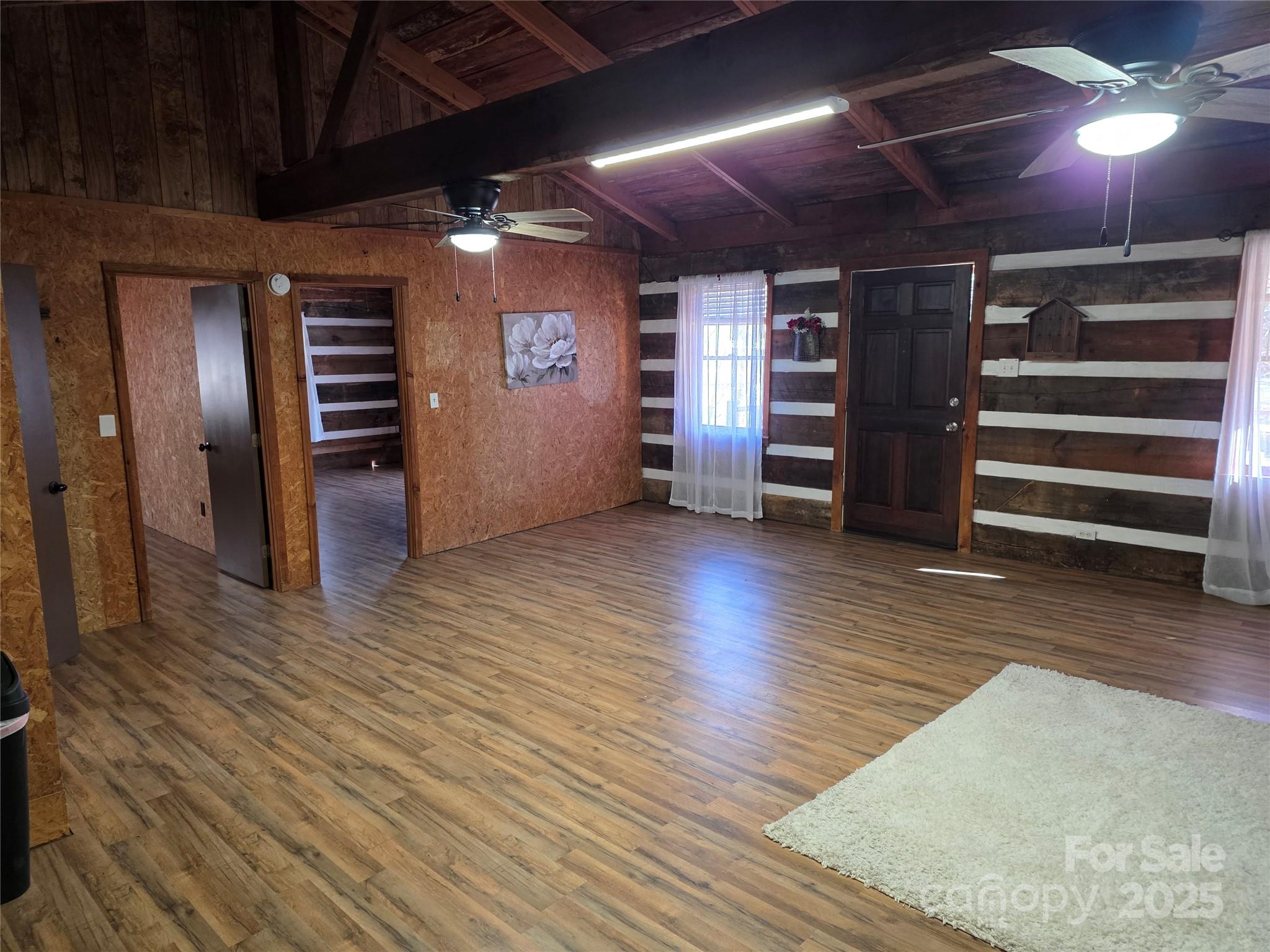 536 Hickory Springs Road Burnsville, NC 28714 - Photo 10 of 26 a view of an empty room with furniture and a kitchen