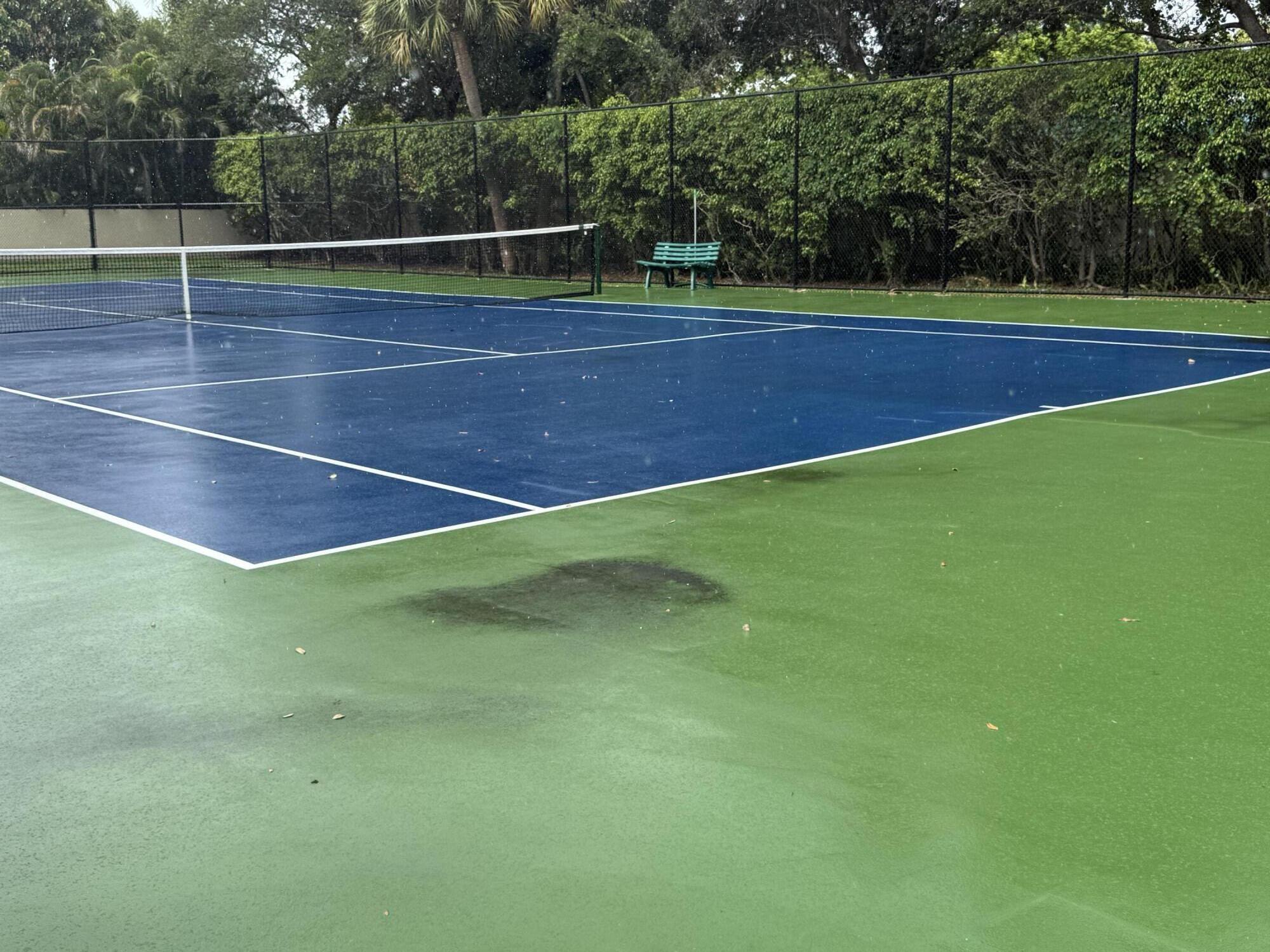 3130 Millwood Terrace, Unit 1110 Boca Raton, FL 33431 - Photo 14 of 18 a view of an outdoor space and tennis court