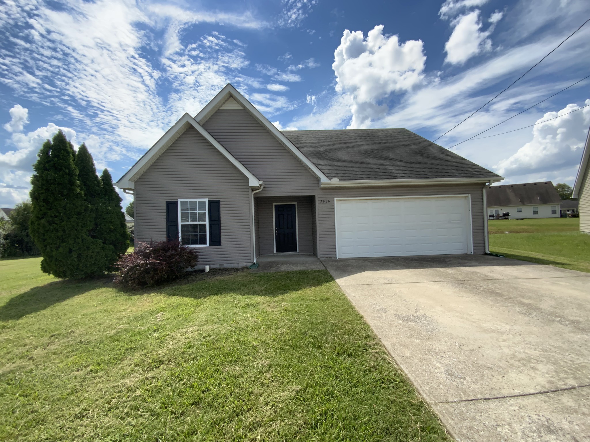 a view of a house with a yard and garage