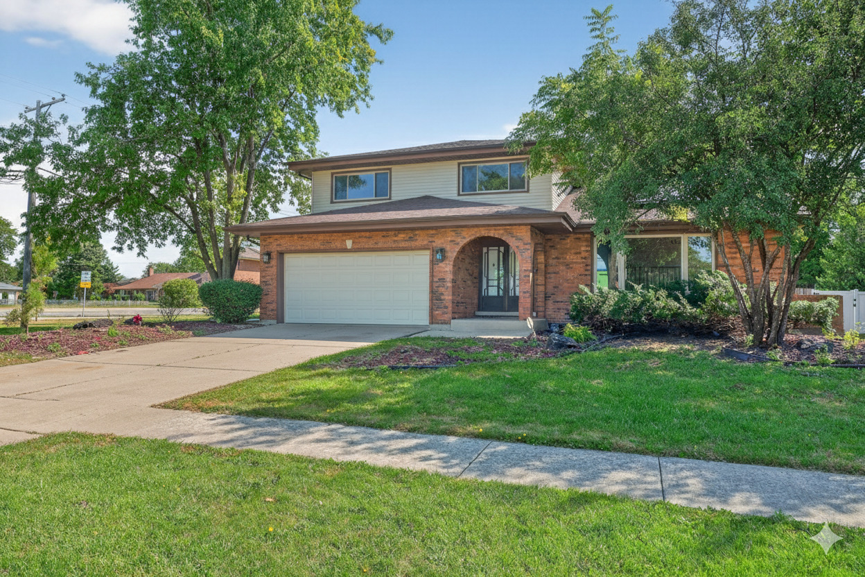 a front view of a house with a garden