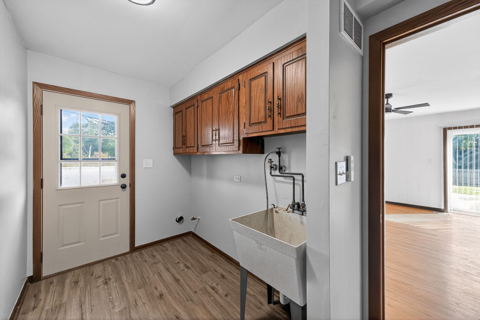 7501 Cambridge Road Darien, IL 60561 - Photo 11 of 22 a kitchen with a sink a refrigerator and cabinets