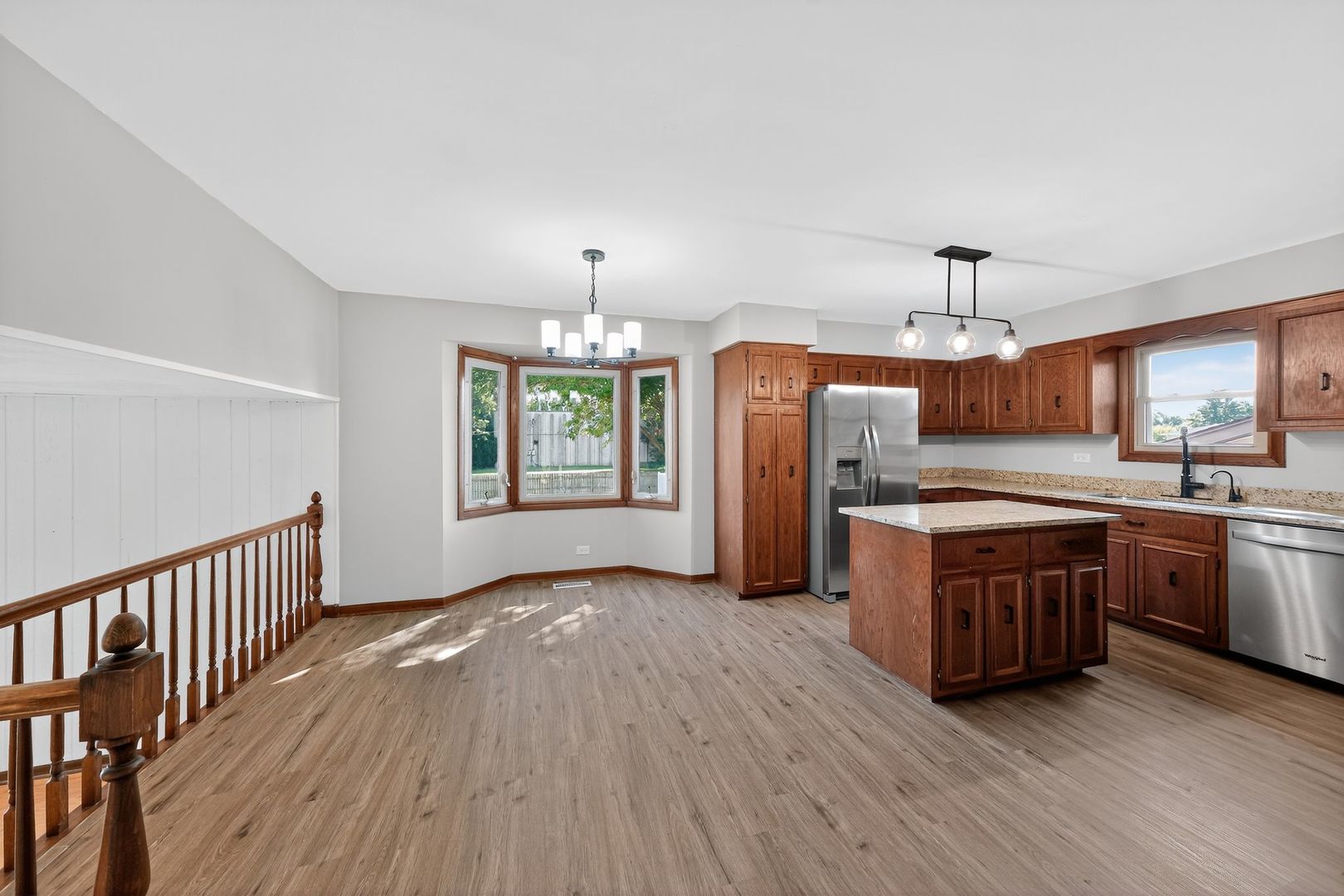 7501 Cambridge Road Darien, IL 60561 - Photo 12 of 22 a large kitchen with cabinets wooden floor and stainless steel appliances