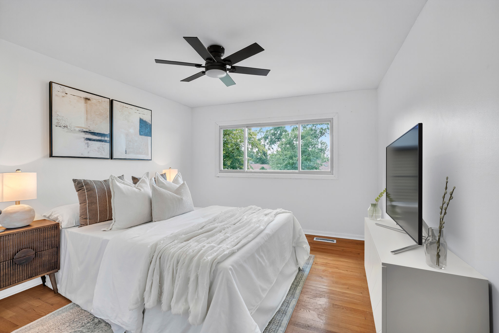 7501 Cambridge Road Darien, IL 60561 - Photo 16 of 22 a bedroom with a large bed and a flat screen tv