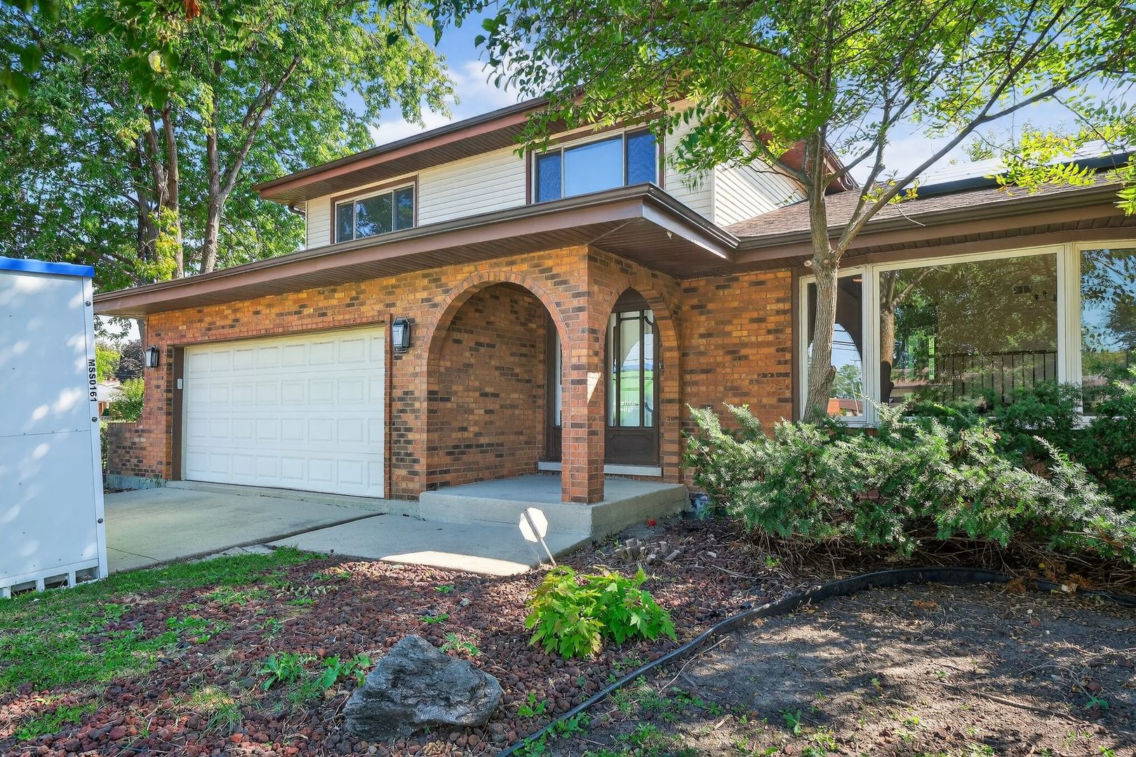 7501 Cambridge Road Darien, IL 60561 - Photo 3 of 22 a front view of a house with garden