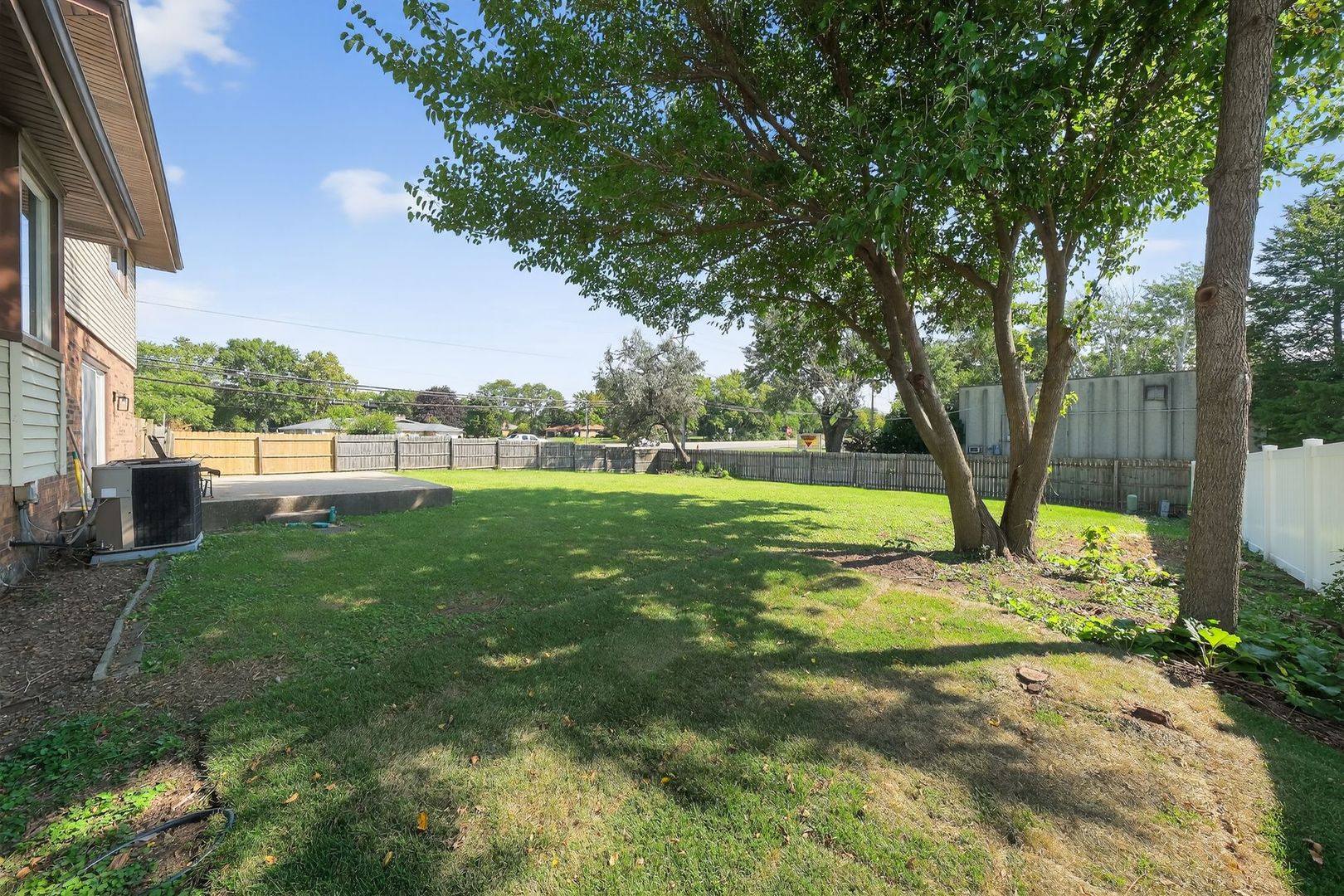 7501 Cambridge Road Darien, IL 60561 - Photo 6 of 22 a view of green field with trees in the background