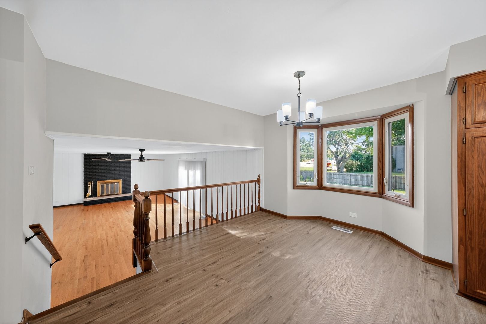 7501 Cambridge Road Darien, IL 60561 - Photo 9 of 22 a view of a room with wooden floor fan and windows