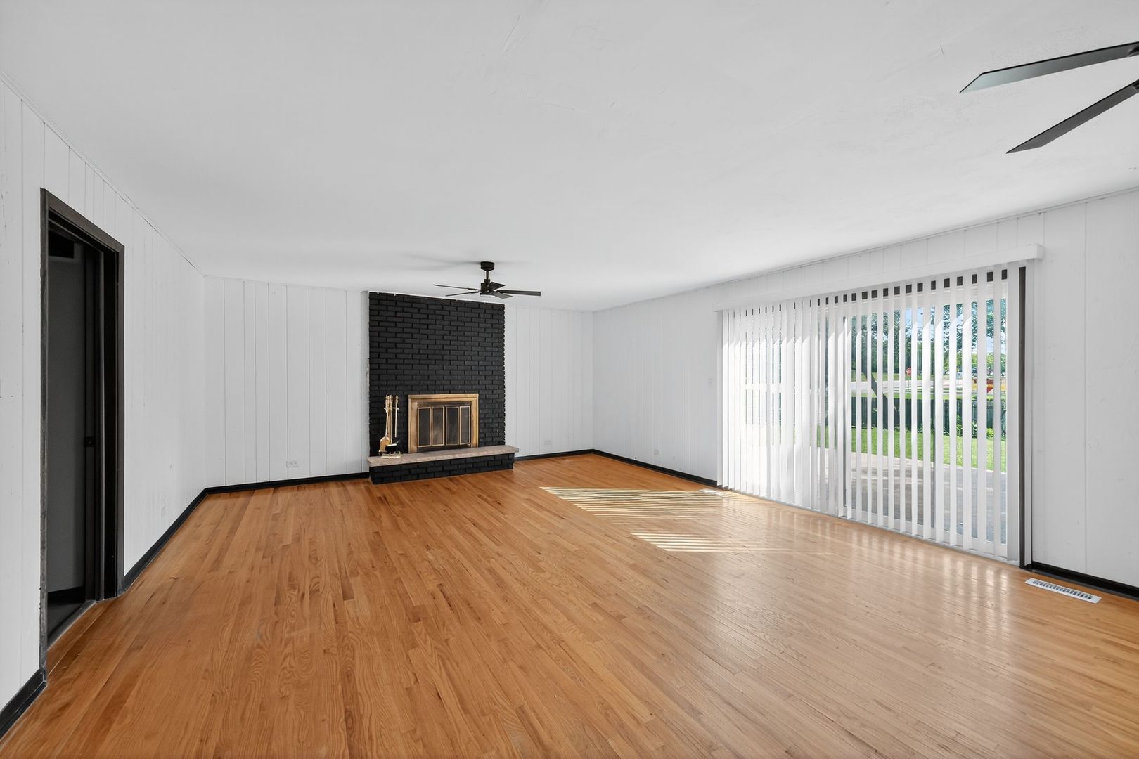 7501 Cambridge Road Darien, IL 60561 - Photo 10 of 22 a view of empty room with wooden floor and fan