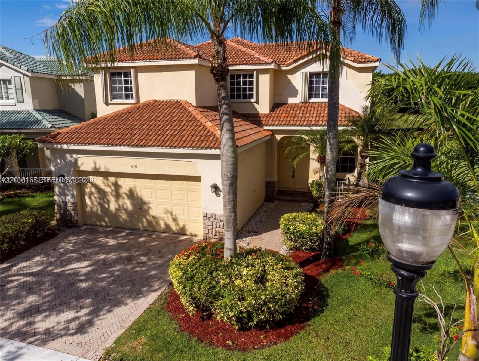 618 Willow Bend Road, Unit 618 Weston, FL 33327 - Photo 2 of 9 a front view of a house with a yard garden and outdoor seating