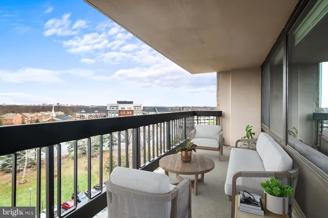 a view of a balcony with chairs and a table