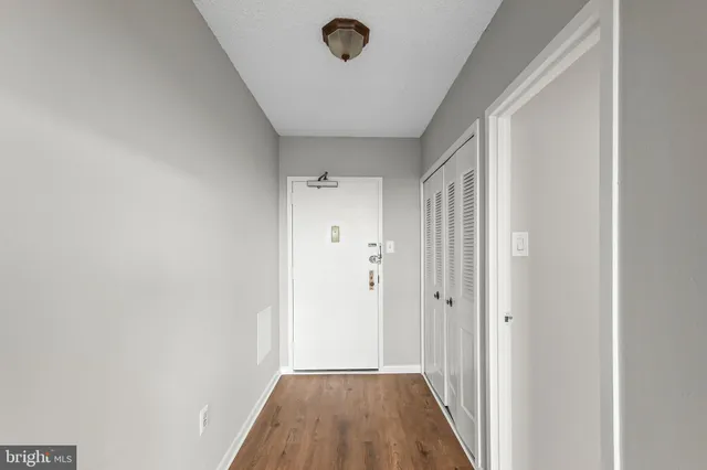 a view of a hallway with wooden floor