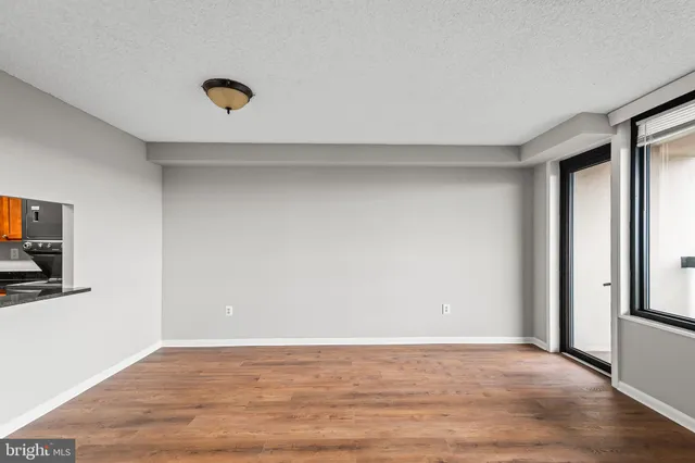 a view of a livingroom with wooden floor and a flat screen tv