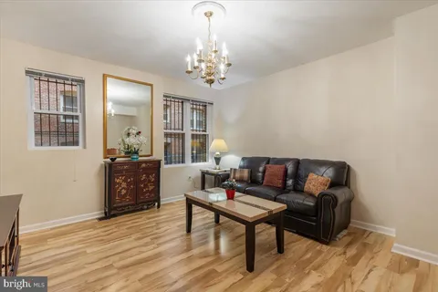 a living room with furniture and a chandelier