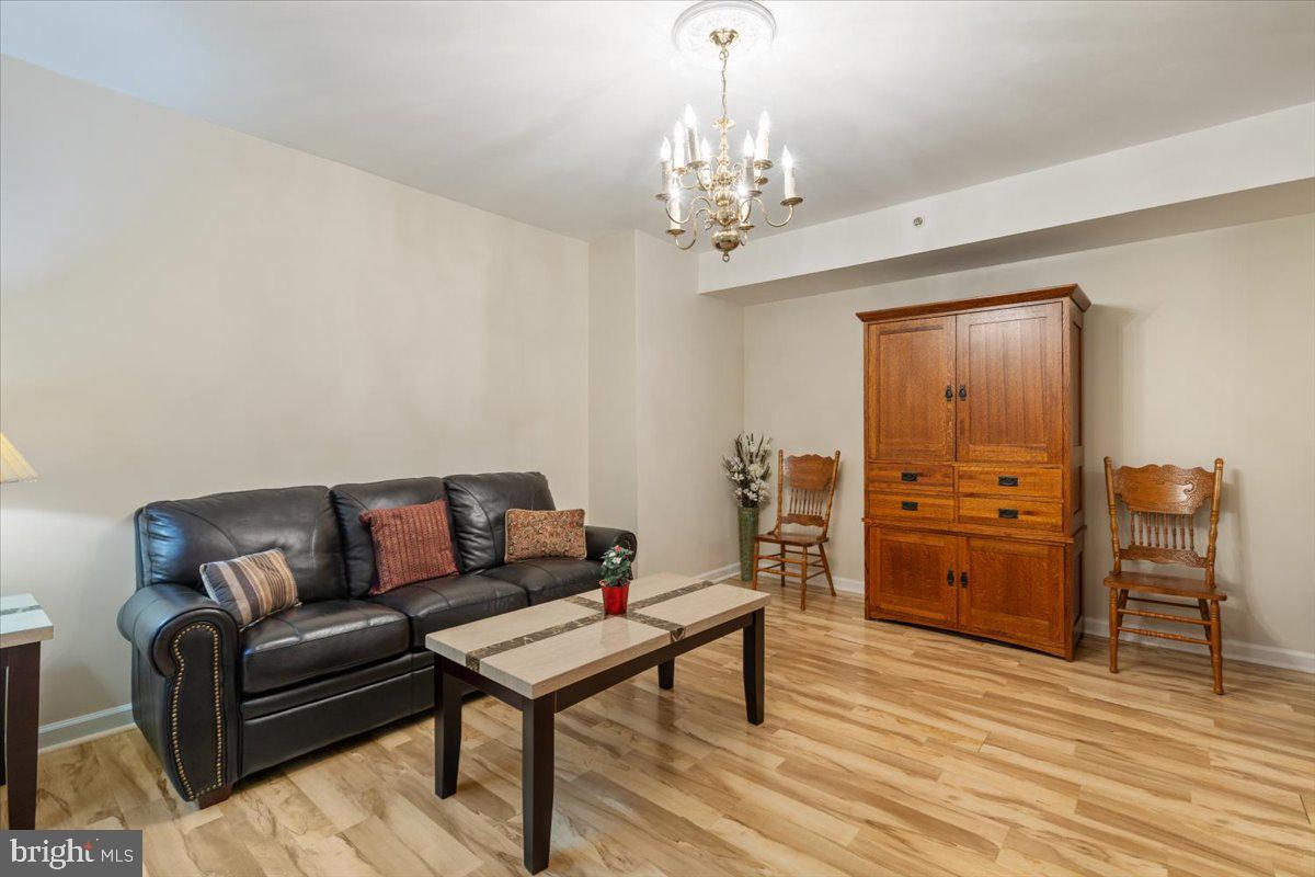 1458 Columbia Road Northwest, Unit 105 Washington, DC 20009 - Photo 12 of 39 a living room with furniture and wooden floor