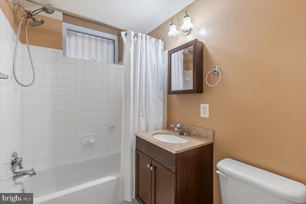 1458 Columbia Road Northwest, Unit 105 Washington, DC 20009 - Photo 19 of 39 a bathroom with a sink vanity mirror and toilet
