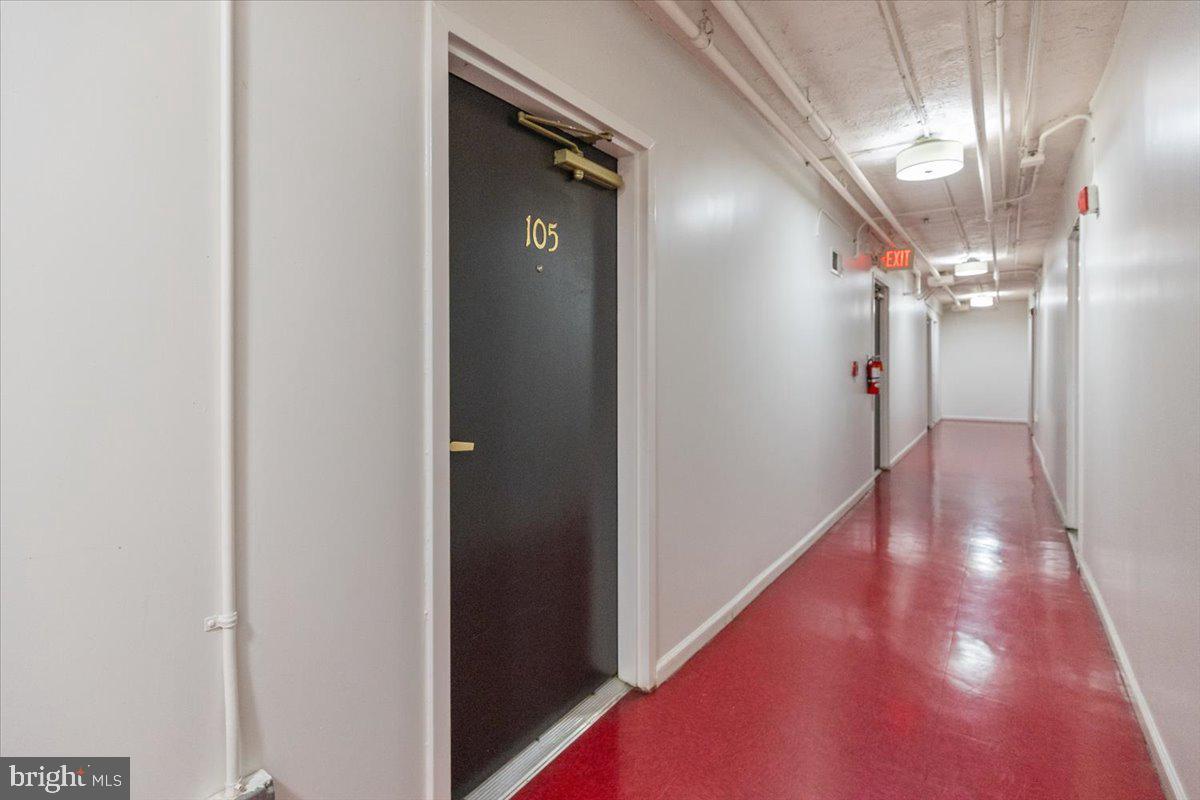 1458 Columbia Road Northwest, Unit 105 Washington, DC 20009 - Photo 25 of 39 a view of a hallway with wooden floor