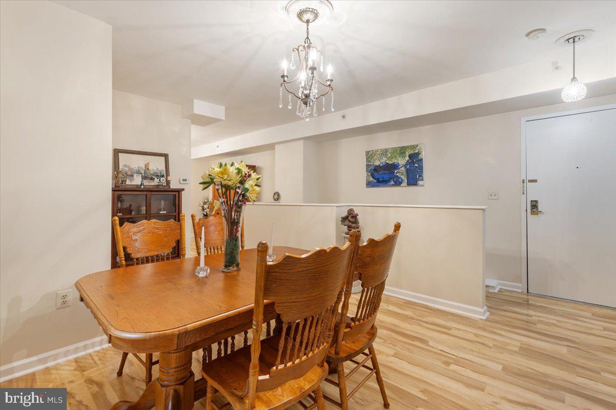 1458 Columbia Road Northwest, Unit 105 Washington, DC 20009 - Photo 7 of 39 a view of a dining room with furniture and chandelier