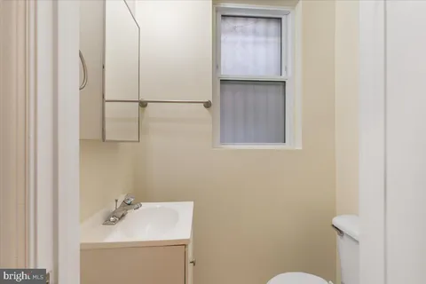 a bathroom with a sink a toilet and vanity