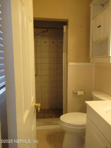 a bathroom with a toilet and shower