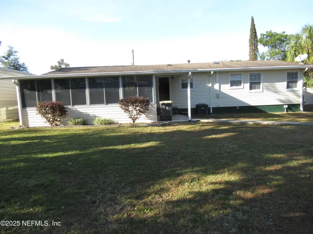 a front view of a house with a yard fire pit and outdoor seating