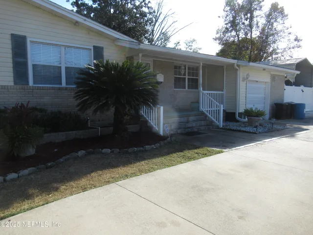 a front view of house with yard and trees around