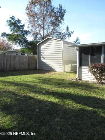 a view of a house with yard and a garden