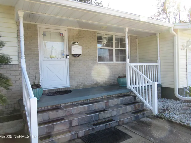 a view of porch with wooden floor and a window