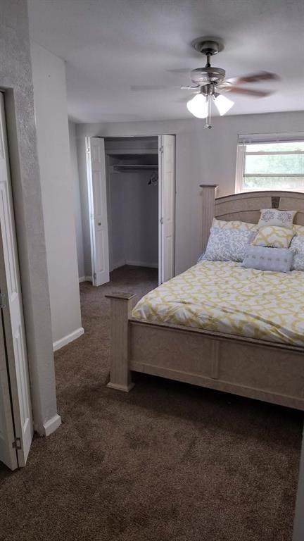 304 Ridgewood Drive Tool, TX 75143 - Photo 11 of 12 Bedroom with a ceiling fan, dark colored carpet, and a closet